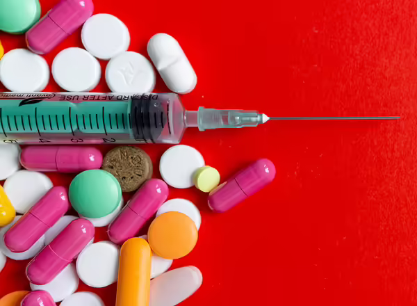 pile of medicine pills and injection