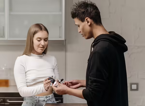 man assisting woman with insulin shot and monitoring