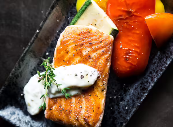 grilled salmon on a plate with vegetables
