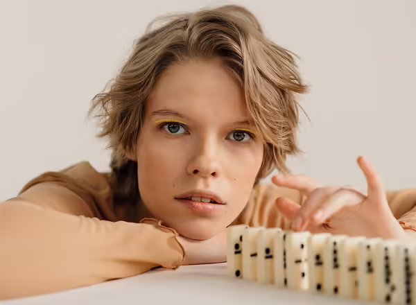 person stacking dominos in a line