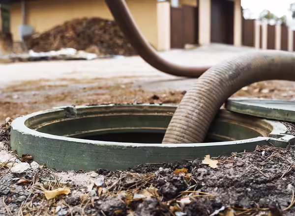 Pipe in the drainage pit. Pumping out sewage from a septic tank.