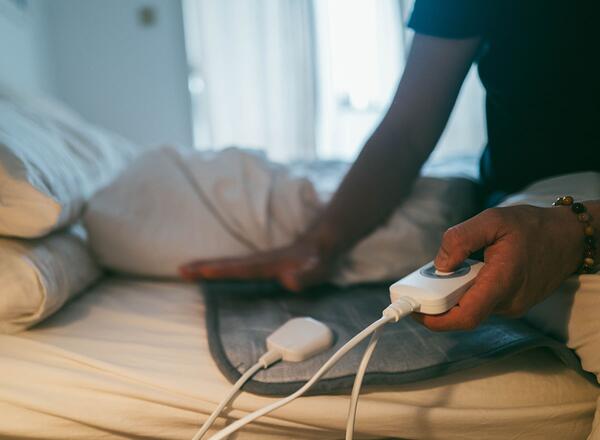person operating an electric blanket
