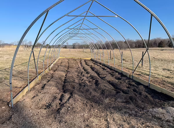 bend metal tubing over tilled up soil