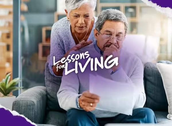 Older women leaning on older man looking at papers