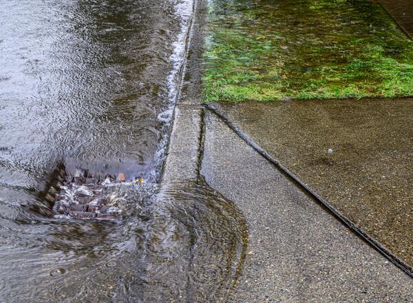 Storm drain being inundated with water.