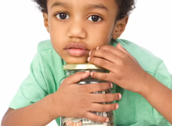 young boy with jar of coins