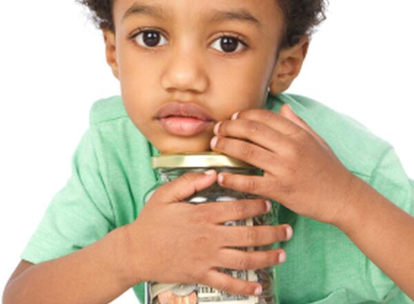 young boy with jar of coins
