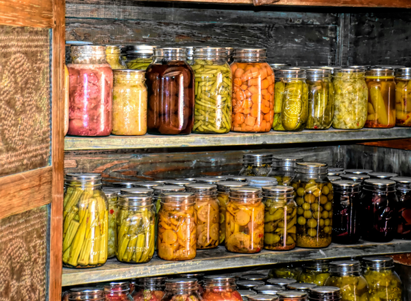 Jars of assorted vegetables and fruits.