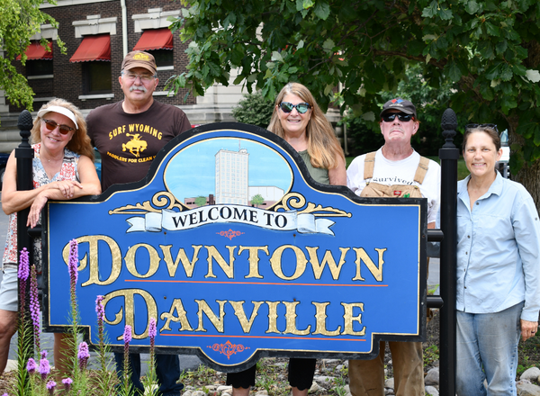 Volunteers standing behind a Downtown Danville Sign.