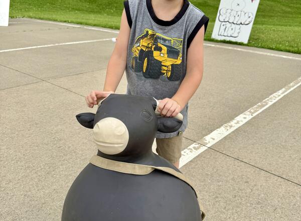 Reid Burbach is getting his bull ready for his "8-second Ride" during the annual 4-H Federation Cloverbud Round-Up.