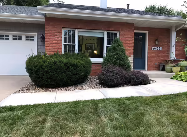 front of house with traditional landscaping design