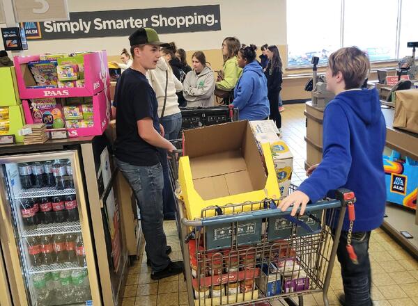 youth at a grocery store checking out