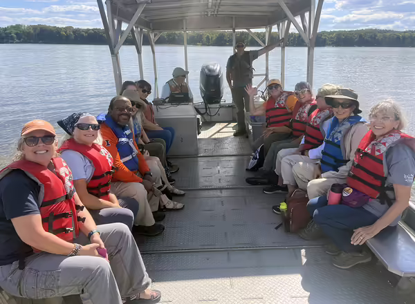 People in life vests on a boat
