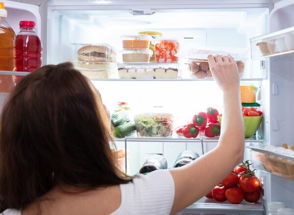 woman looking in fridge