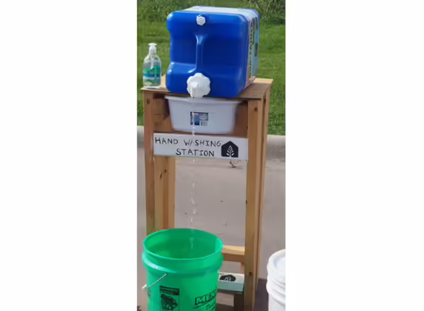 stand with containers and buckets to run water from and into