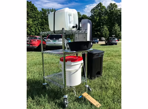 stand with containers and buckets to run water from and into