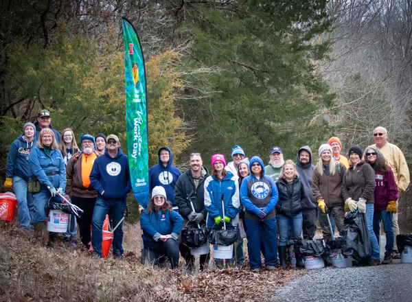 A group of volunteers pose in nature