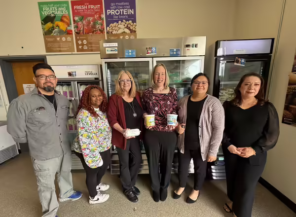the staff at Two Rivers proudly holds IL-EATS product