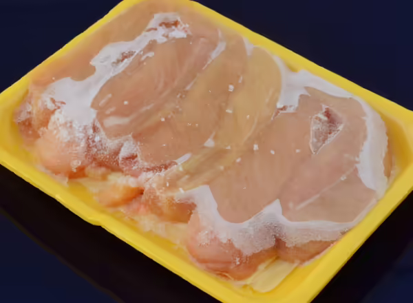 package of freezer-burned raw chicken breasts