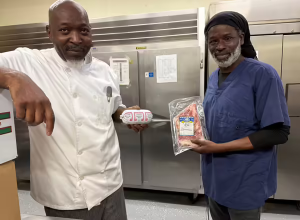Joseph Center chefs hold up proteins from IL-EATS