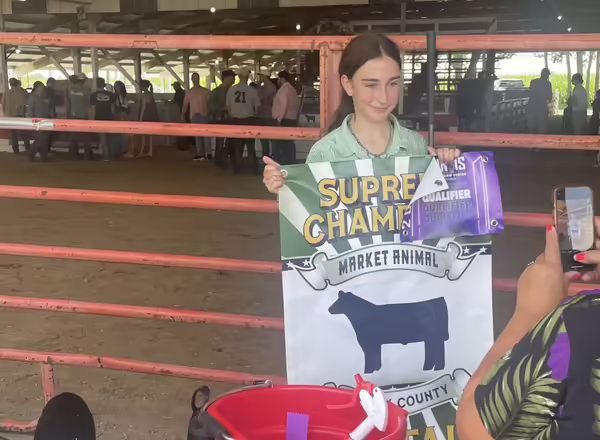 4-H member holding up a banner
