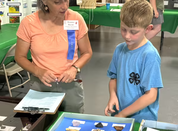 blonde boy shows woman his rock collection