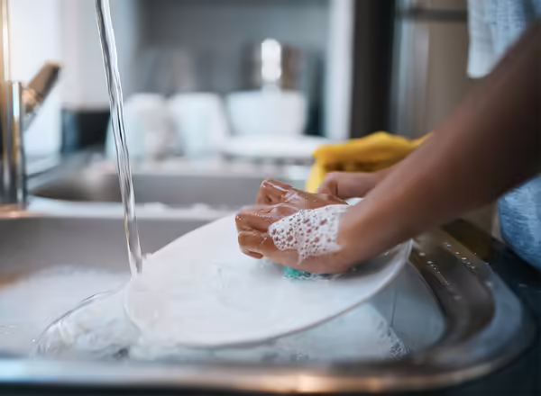 washing dishes at kitchen sink
