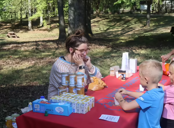 Volunteers teaching youth about pumpkins
