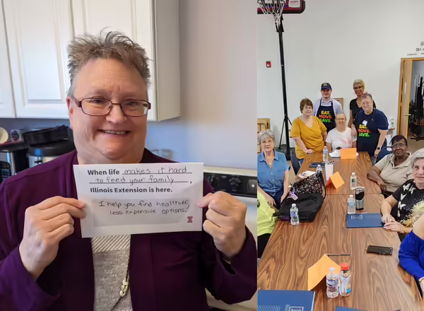 Janet Moody holds up a paper sign that reads ""When life make it hard to feed your family, Illinois Extension is here. I help you find healthier, less expensive options!"
