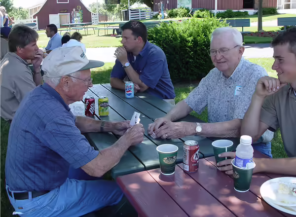 people sitting at a picnic table