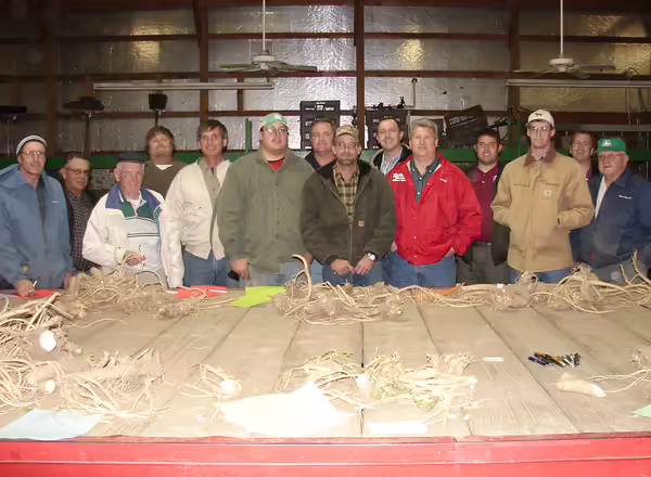 group of people standing behind a trailer