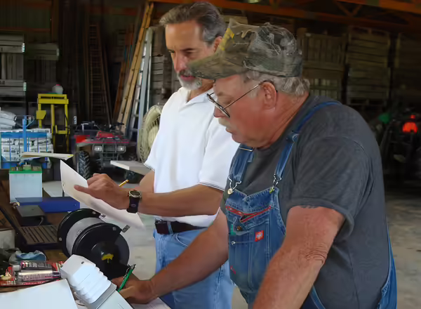 two people looking at a paper