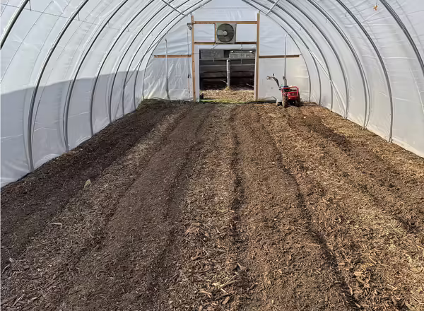high tunnel with freshly tilled soil