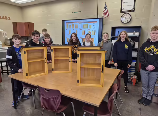 Student from ROVA High School stand by the Little Art Gallery boxes they constructed.