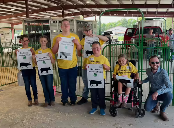 Kevin Carey poses with five youth who participated in 4-H No Limits Livestock show