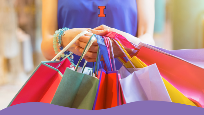 Woman holding different colored shopping bags in her hands.