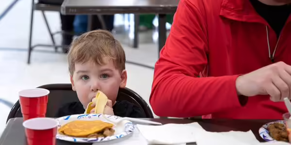 little boy eating a banana