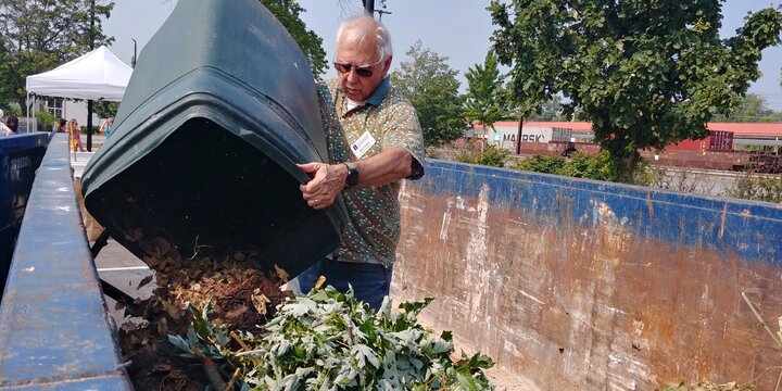 man dumping yard waste to be composted