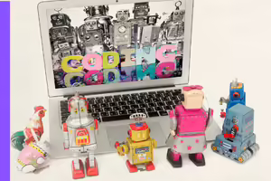 robots in front a laptop looking at the monitor