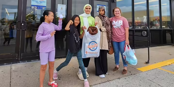Young women standing with shopping bags
