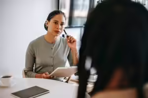 Counselor carefully listening to the concerns of a patient.