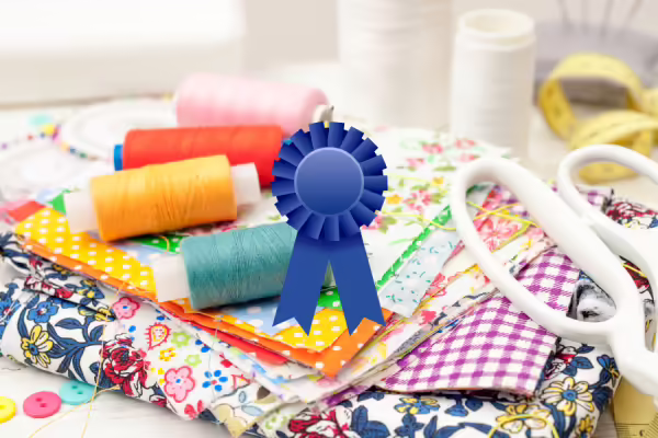Sewing equipment with a graphic of a blue ribbon over the top of the photo.
