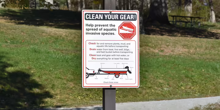 a sign in a park about cleaning a boat