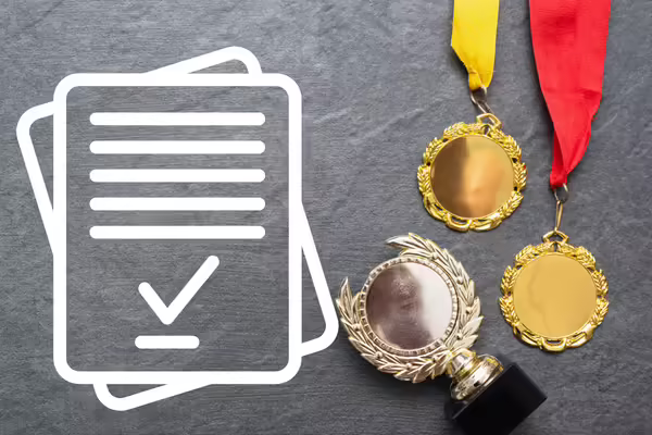 Clipart of an application next to some medals and a trophy