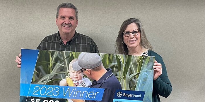 Man and woman holding sign with text 2023 winner