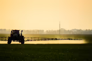 tractor spraying pesticide safely