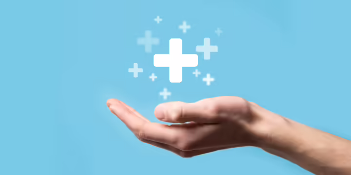 cupped hand with medical sign hovering above