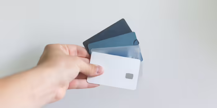 A person holding some credit cards.