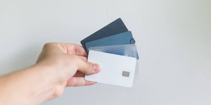 A person holding some credit cards.