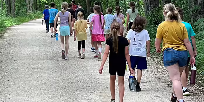group of people walking on a road